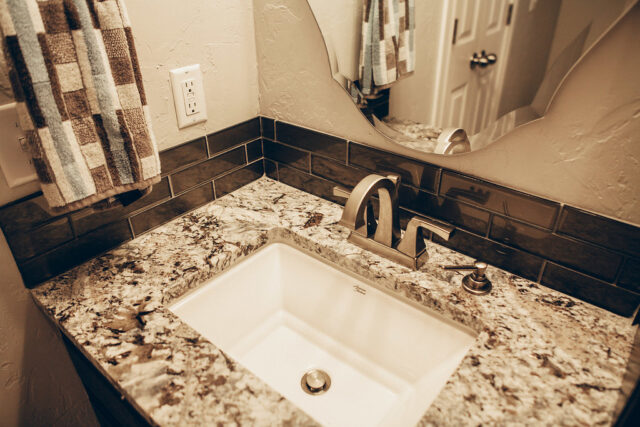bathroom sink with granite countertop